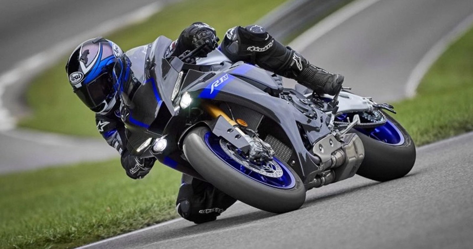 Black and blue Japanese motorcycle turning on the track